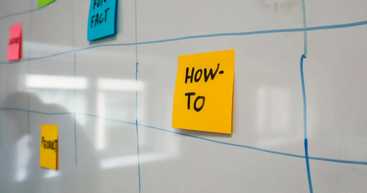 Project schedule whiteboard covered with colorful sticky notes